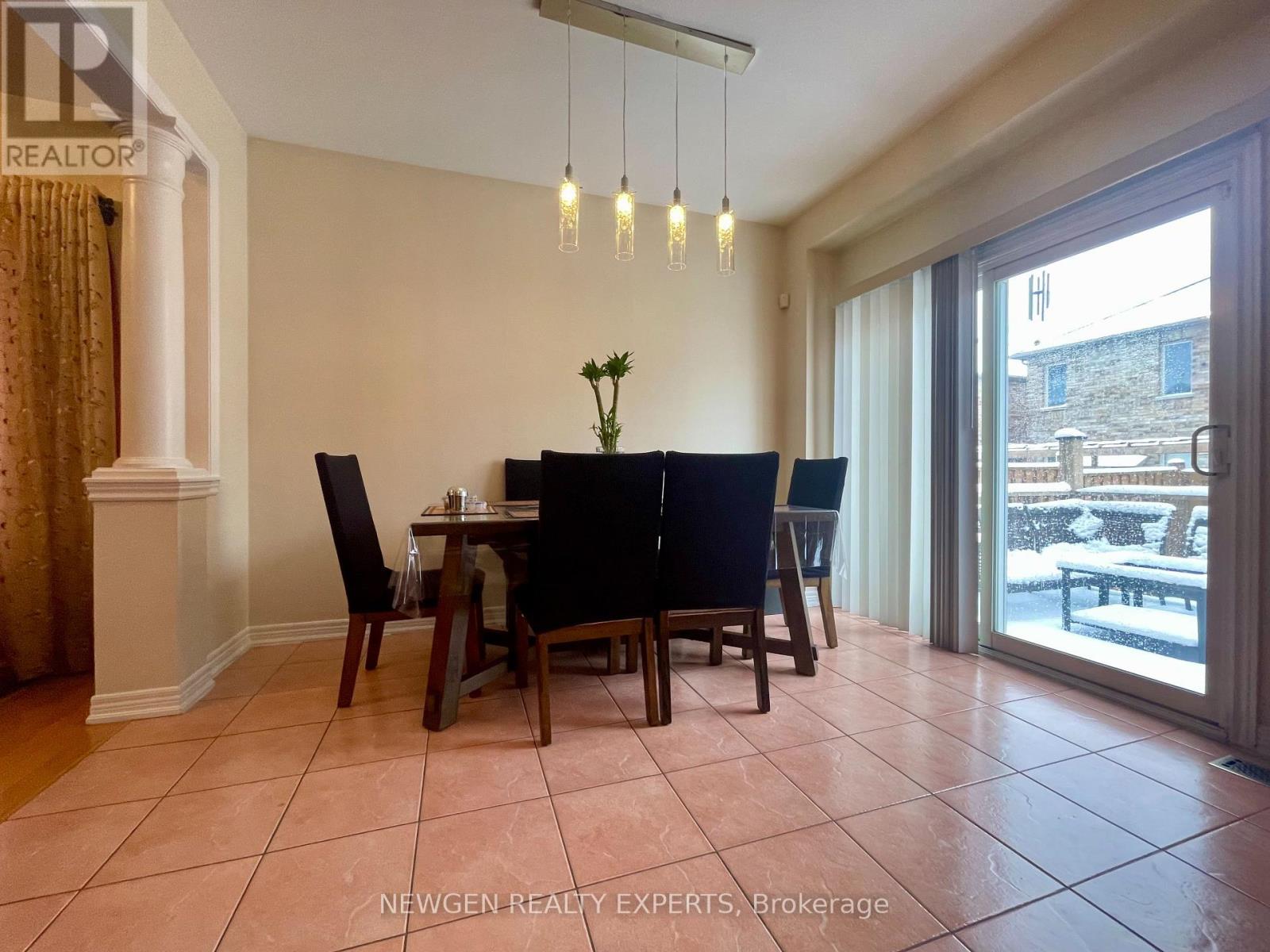 A dining room with a table set for four.