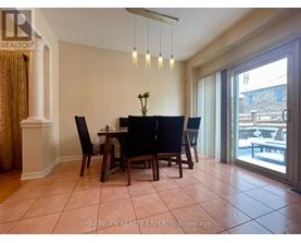 A dining room with a table set for four.