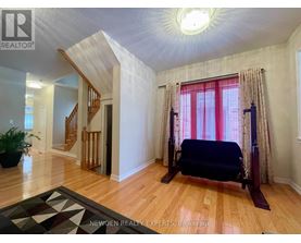 A bedroom with a bed, a window with curtains, and a rug on the floor.