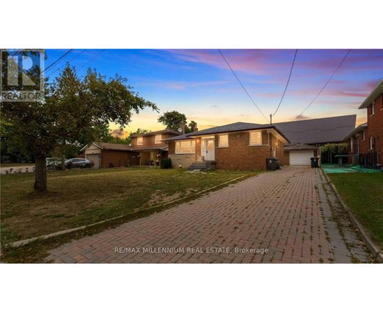 A house with a brick driveway is for sale.
