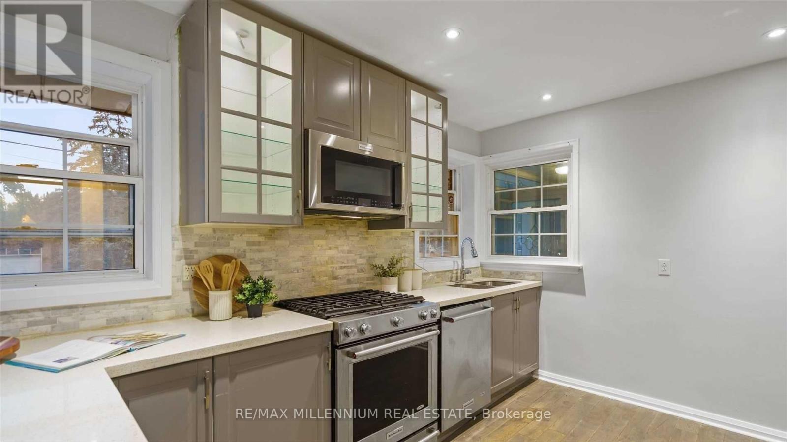 A kitchen with a stove top oven and microwave built into a cabinet.