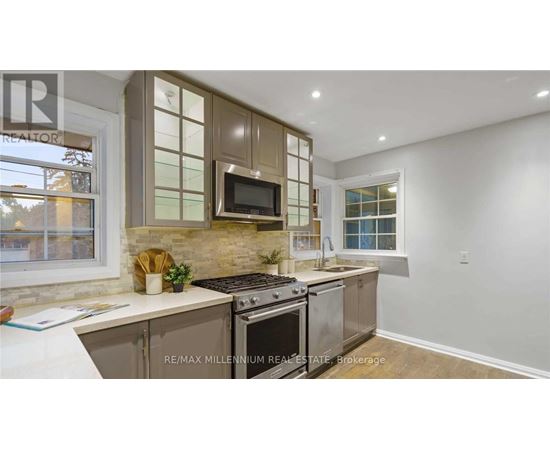 A kitchen with a stove top oven and microwave built into a cabinet.