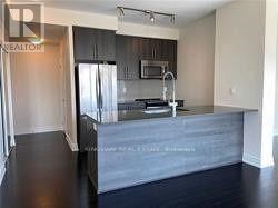 A kitchen with a countertop and a refrigerator.