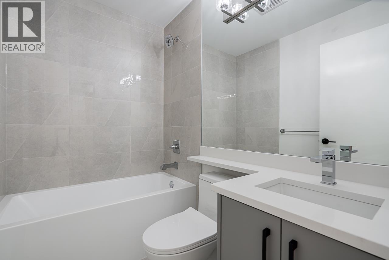 A white toilet sits next to a bathtub in a bathroom.
