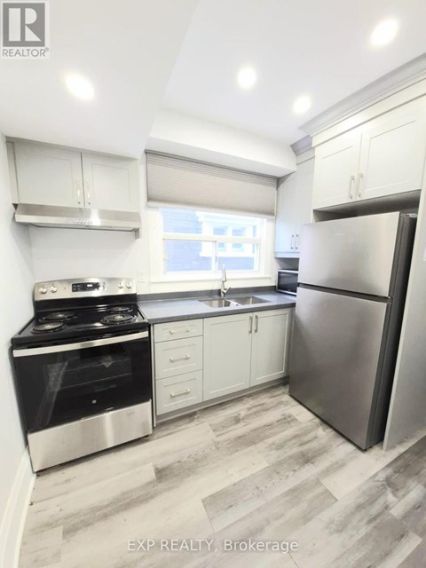 A modern kitchen with stainless steel appliances and white cabinetry.