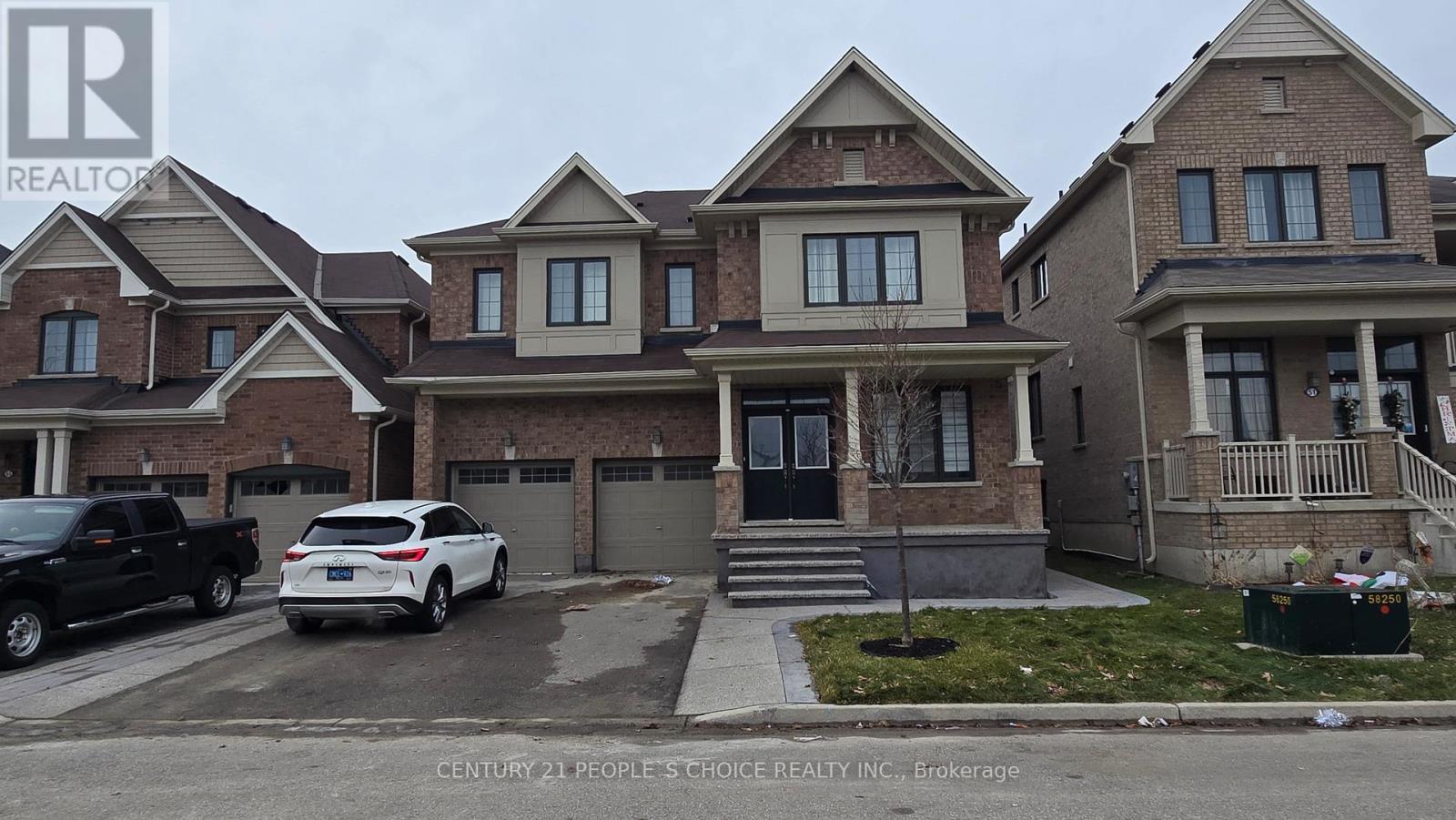 A house with a car parked in front of it.