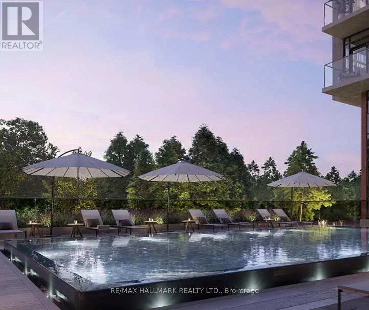 A pool surrounded by lounge chairs and umbrellas at RE/MAX Hallmark Realty LTD.