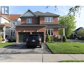 A house with a garage and a car parked in front.