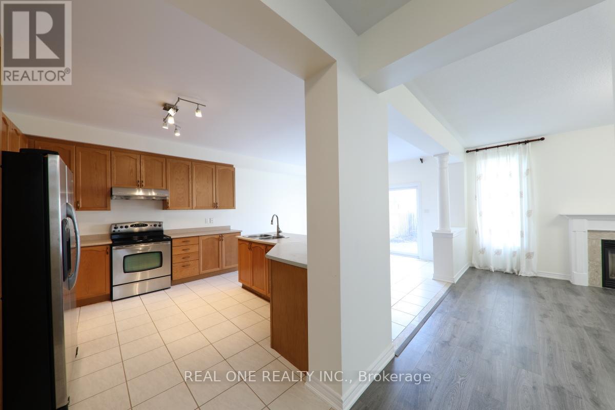 A kitchen with wooden cabinets and a black refrigerator.