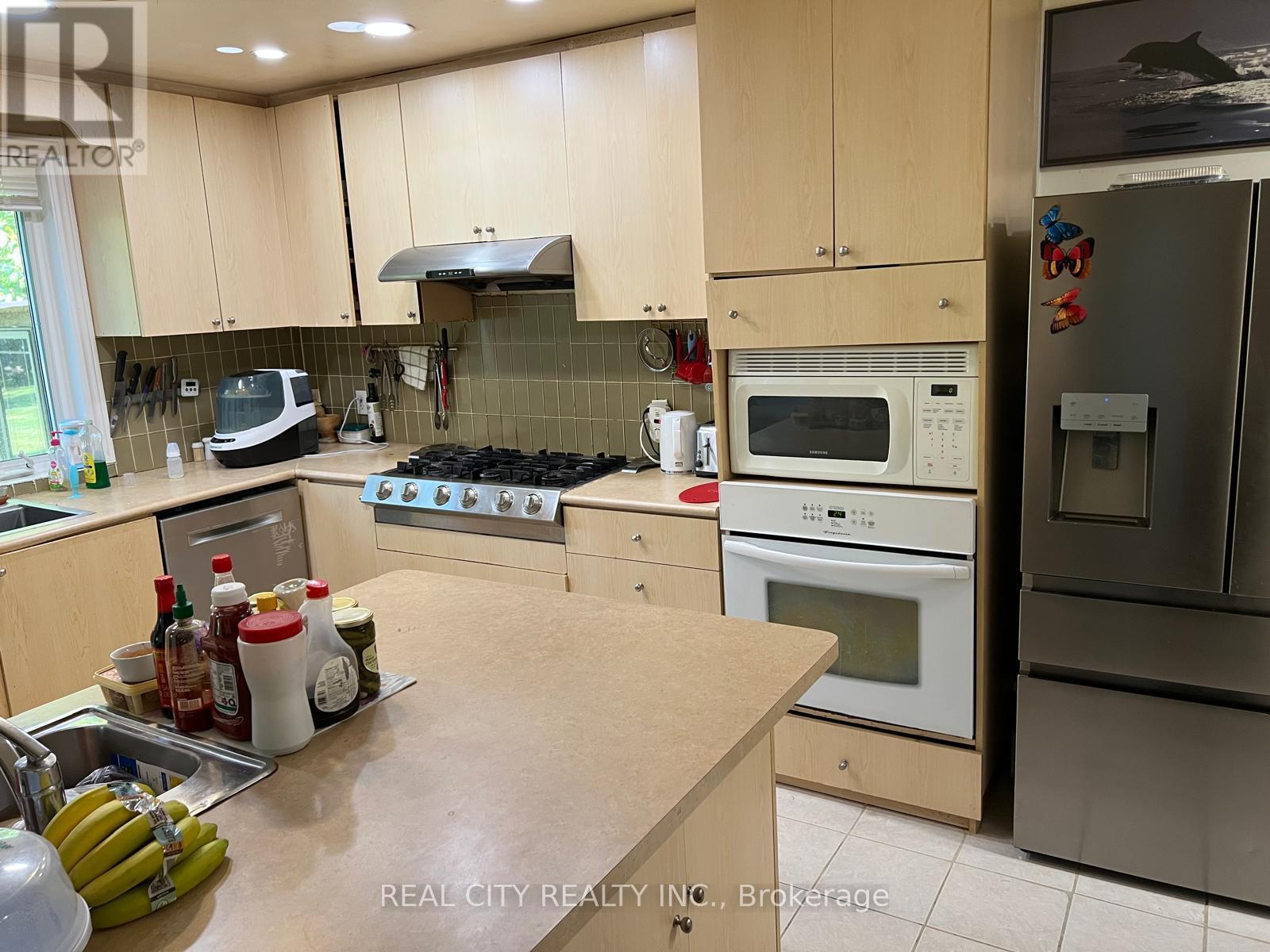A kitchen with wooden cabinets and a stove top oven.