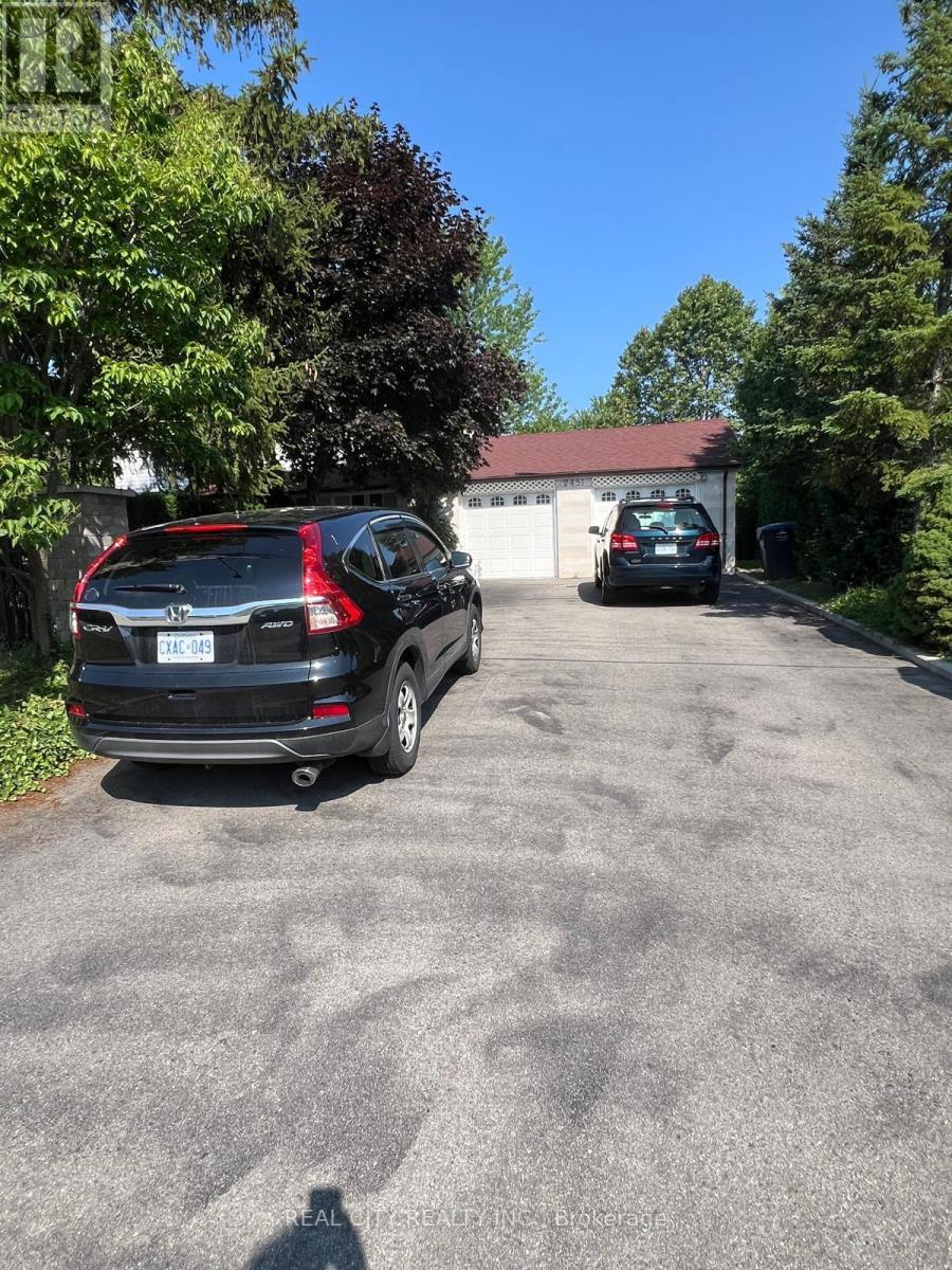 A black Mercedes-Benz SUV is parked in a driveway.