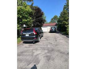 A black Mercedes-Benz SUV is parked in a driveway.