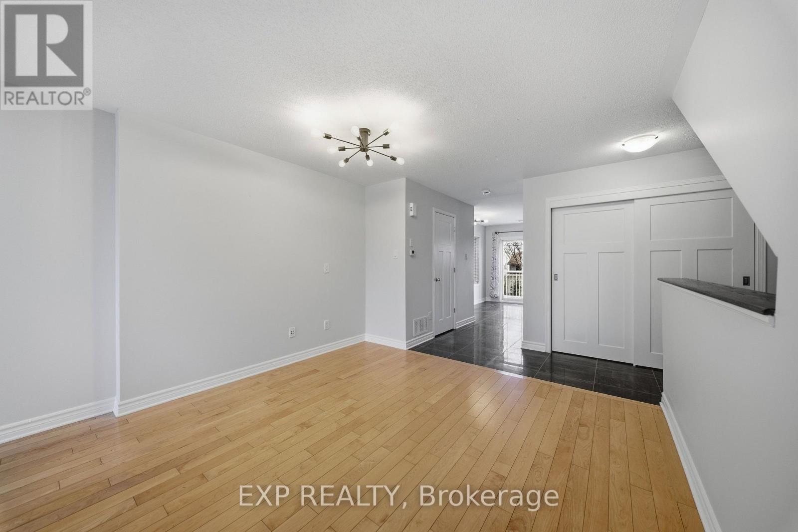A room with wooden flooring and white walls.