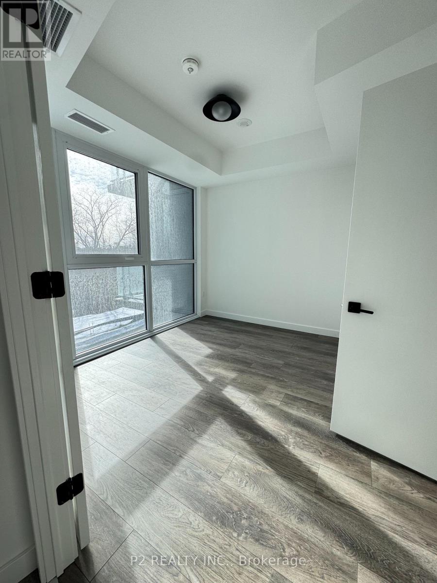 A room with a sliding glass door and a wooden floor.
