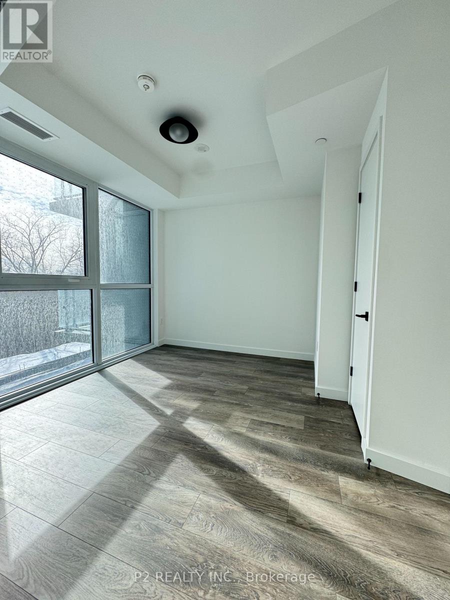 A room with a large window and a sliding glass door.