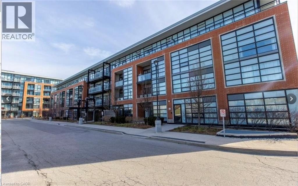A modern building with a glass facade and a no parking sign in front.