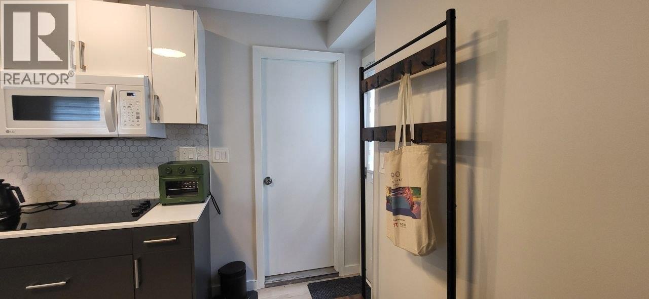 A kitchen with a white microwave above the stove.