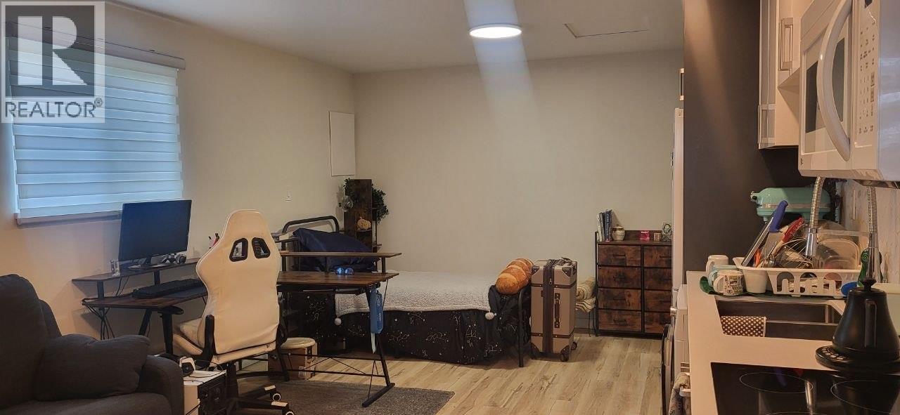A room with a desk, chair, and computer.