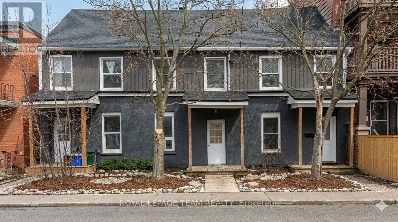 A grey house with a white door and windows.