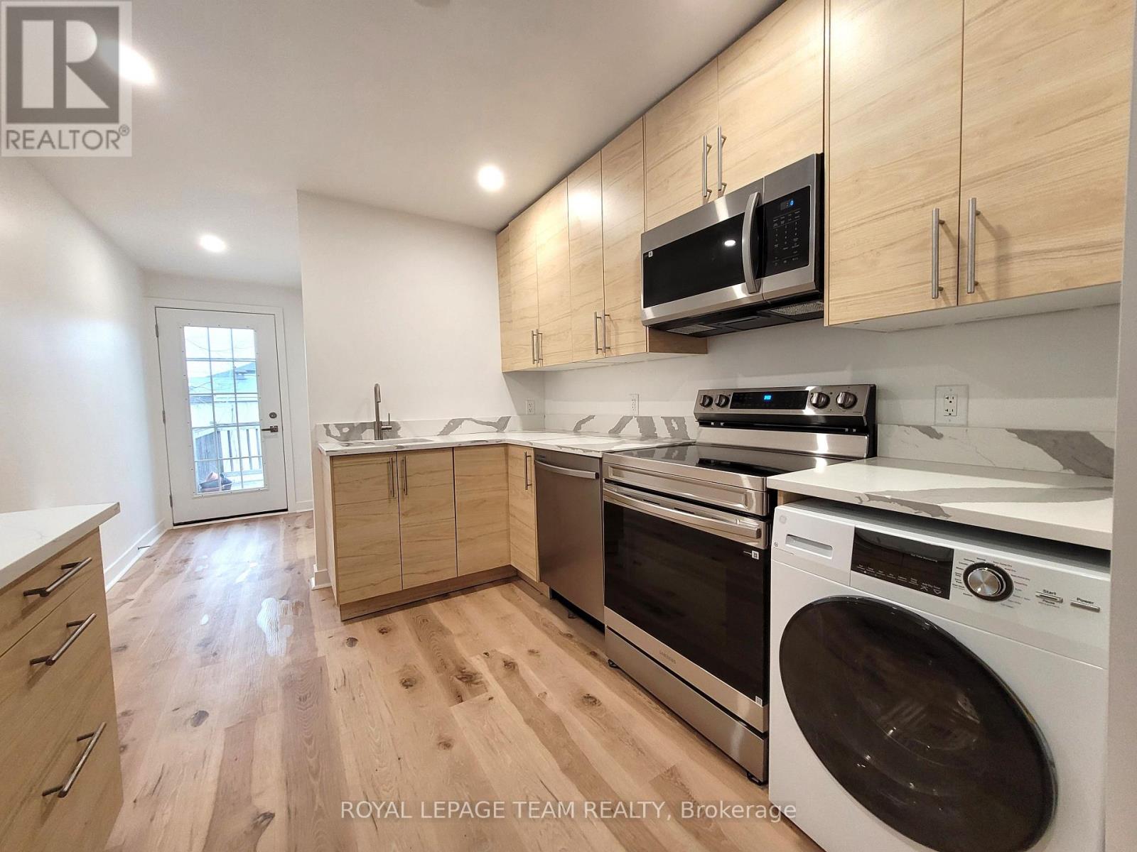 A kitchen with wooden cabinets and stainless steel appliances.