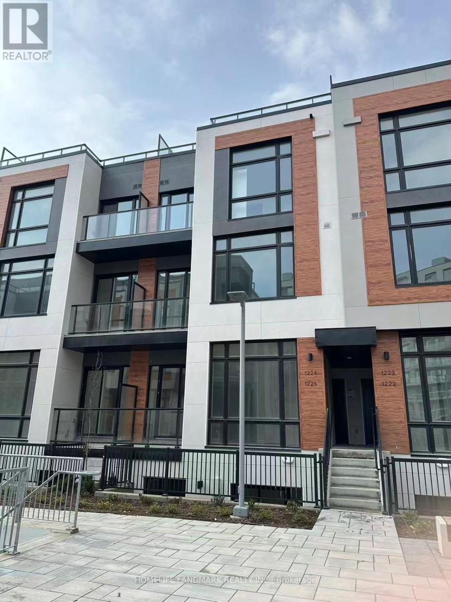 A modern apartment building with balconies and glass doors.