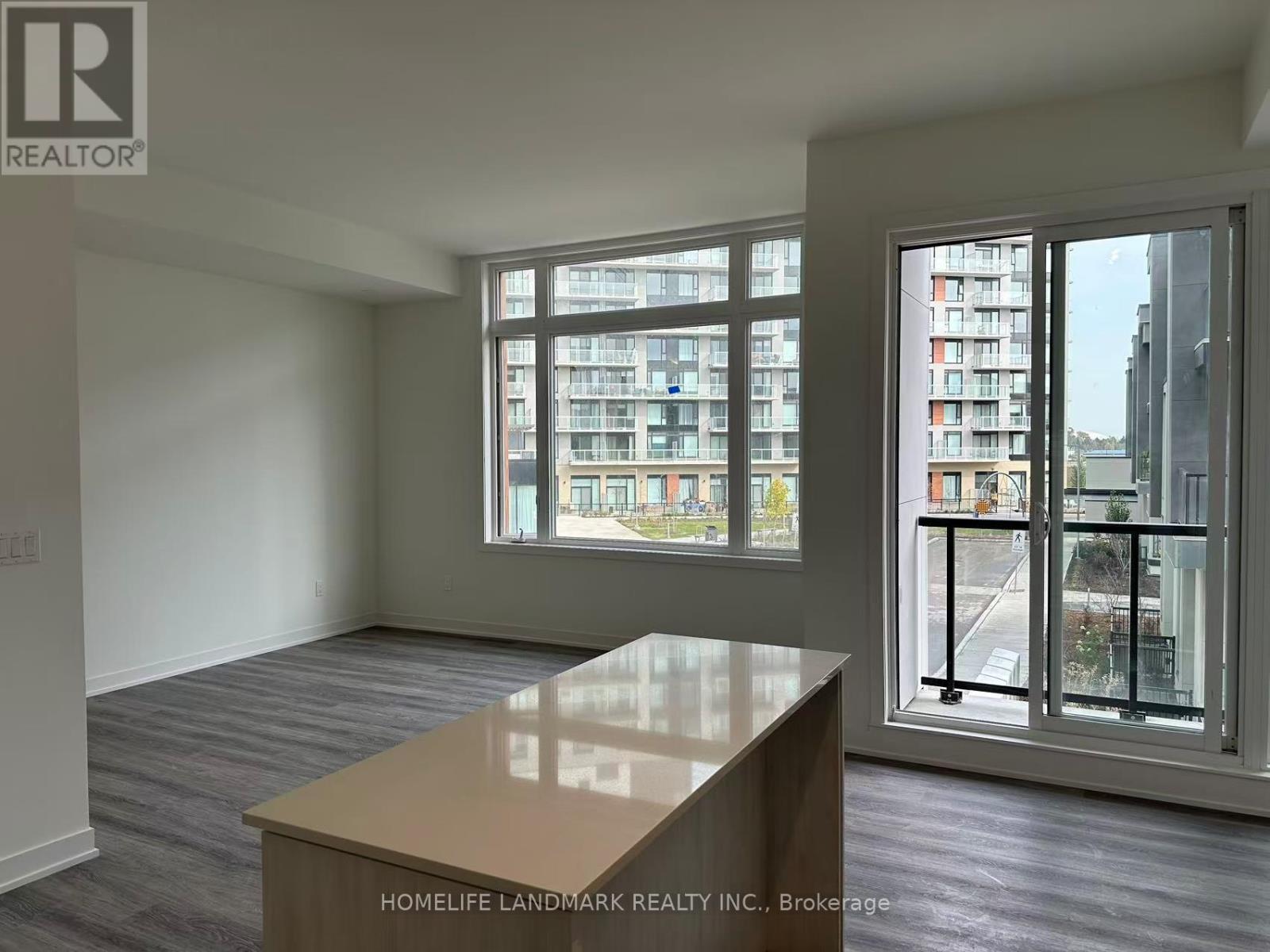 A room with a table and a window overlooking a building.