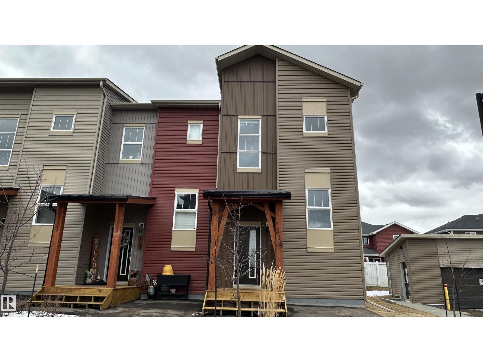 A row of houses with a grey sky in the background.