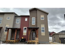 A row of houses with a grey sky in the background.