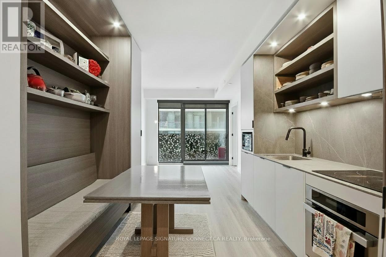 A modern kitchen with a dining table and a sink.