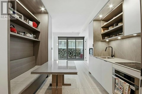 A modern kitchen with a dining table and a sink.