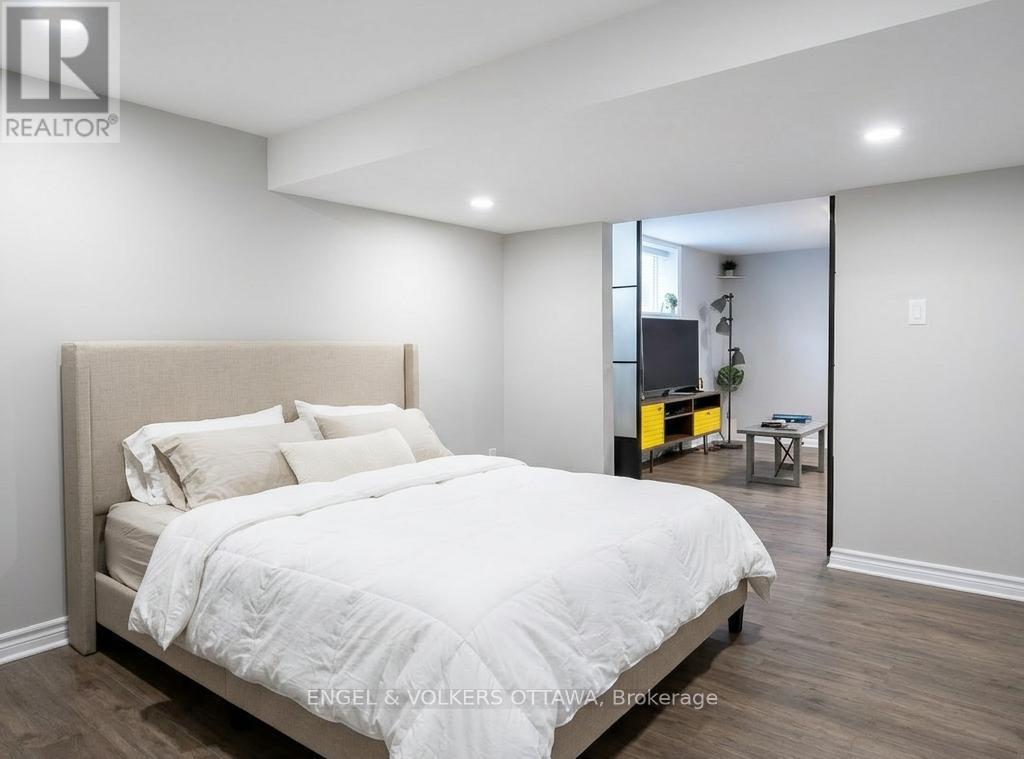 A bedroom with a large bed and a mirror on the wall.
