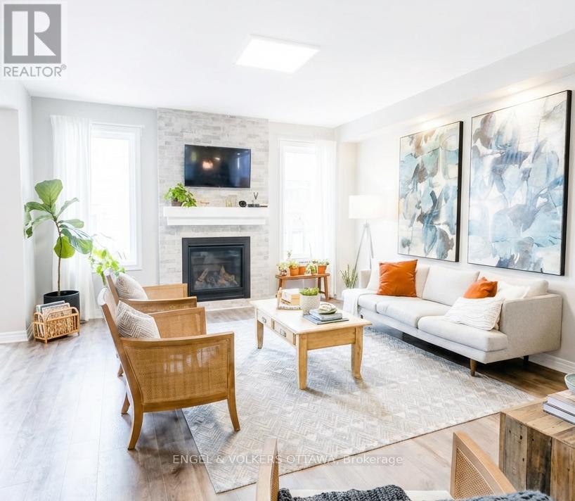 A living room with a fireplace and a painting on the wall.