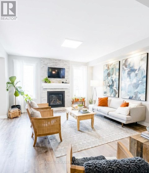 A living room with a fireplace and a painting on the wall.