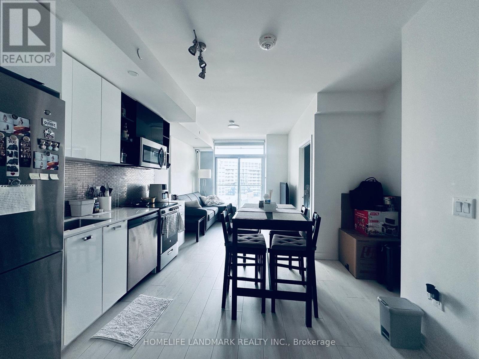 A kitchen with a table and chairs in front of a window.