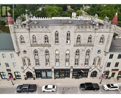 A castle-like building with a parking lot in front.