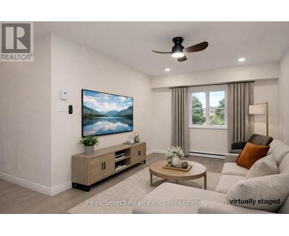 A living room with a flat screen TV mounted on the wall.