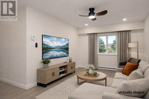 A living room with a flat screen TV mounted on the wall.