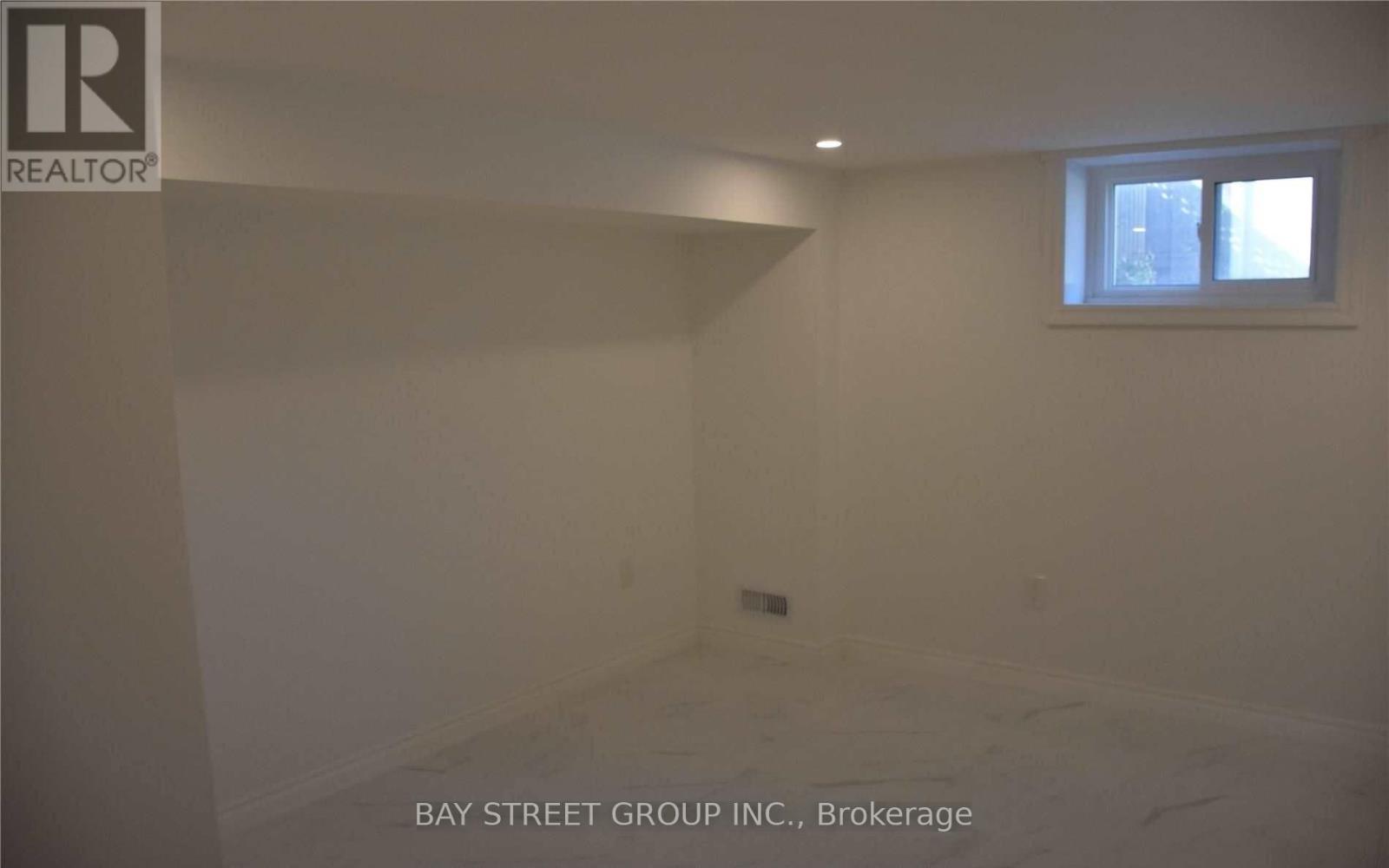 A room with a window and a sign that says REALTOR.
