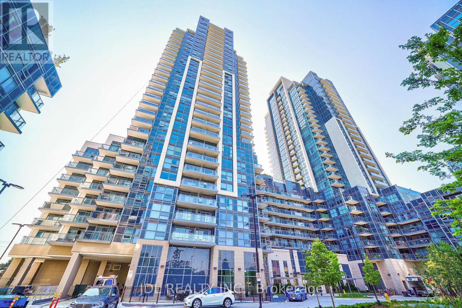 Two tall buildings with blue glass windows are in the foreground.