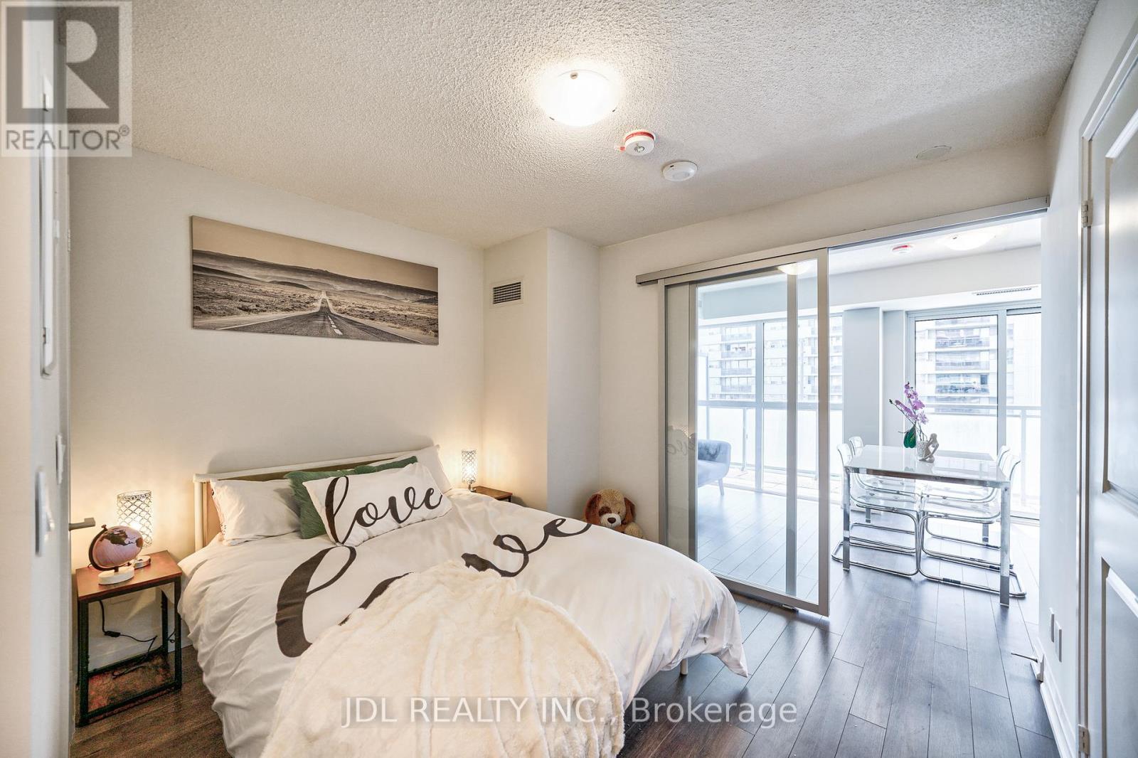 A bedroom with a bed that has the word "love" written on it.