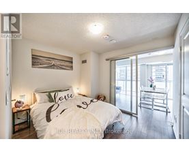 A bedroom with a bed that has the word "love" written on it.
