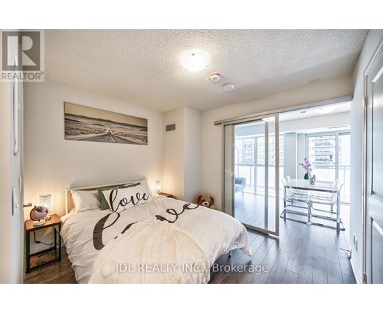 A bedroom with a bed that has the word "love" written on it.