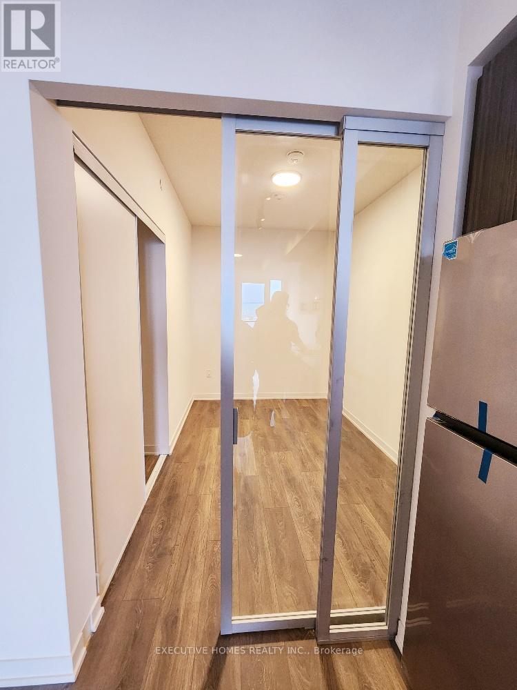 A room with a glass door and a wooden floor.