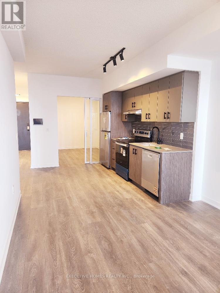 A modern kitchen with wooden floors and a large island.