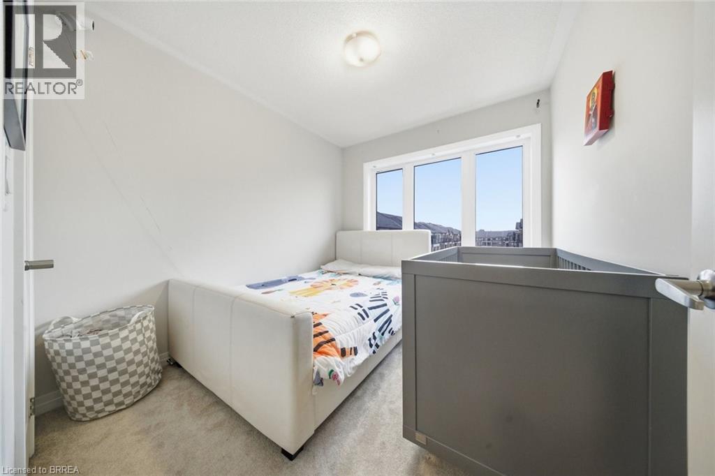 A bedroom with a bed, a dresser, and a window.