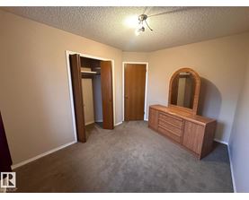 A bedroom with a dresser and mirror.