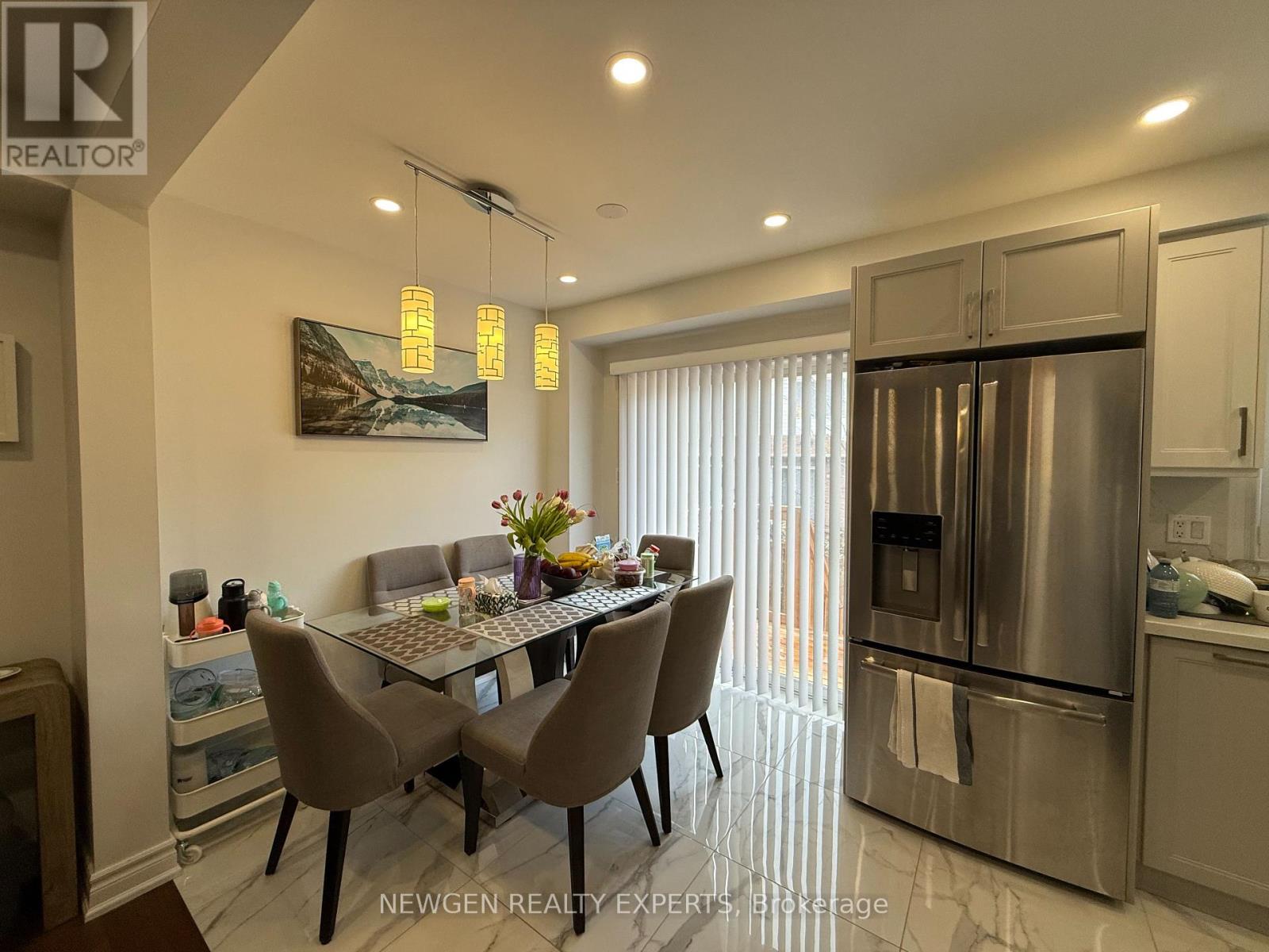 A modern kitchen with a dining table and chairs.