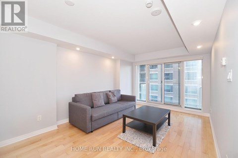 A living room with a grey couch and a coffee table.