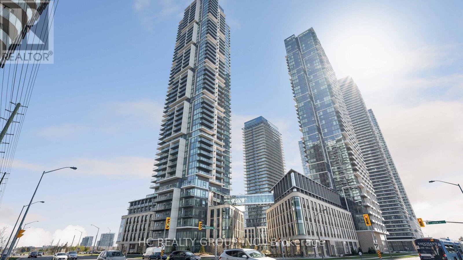 Two tall buildings stand next to each other in a city.