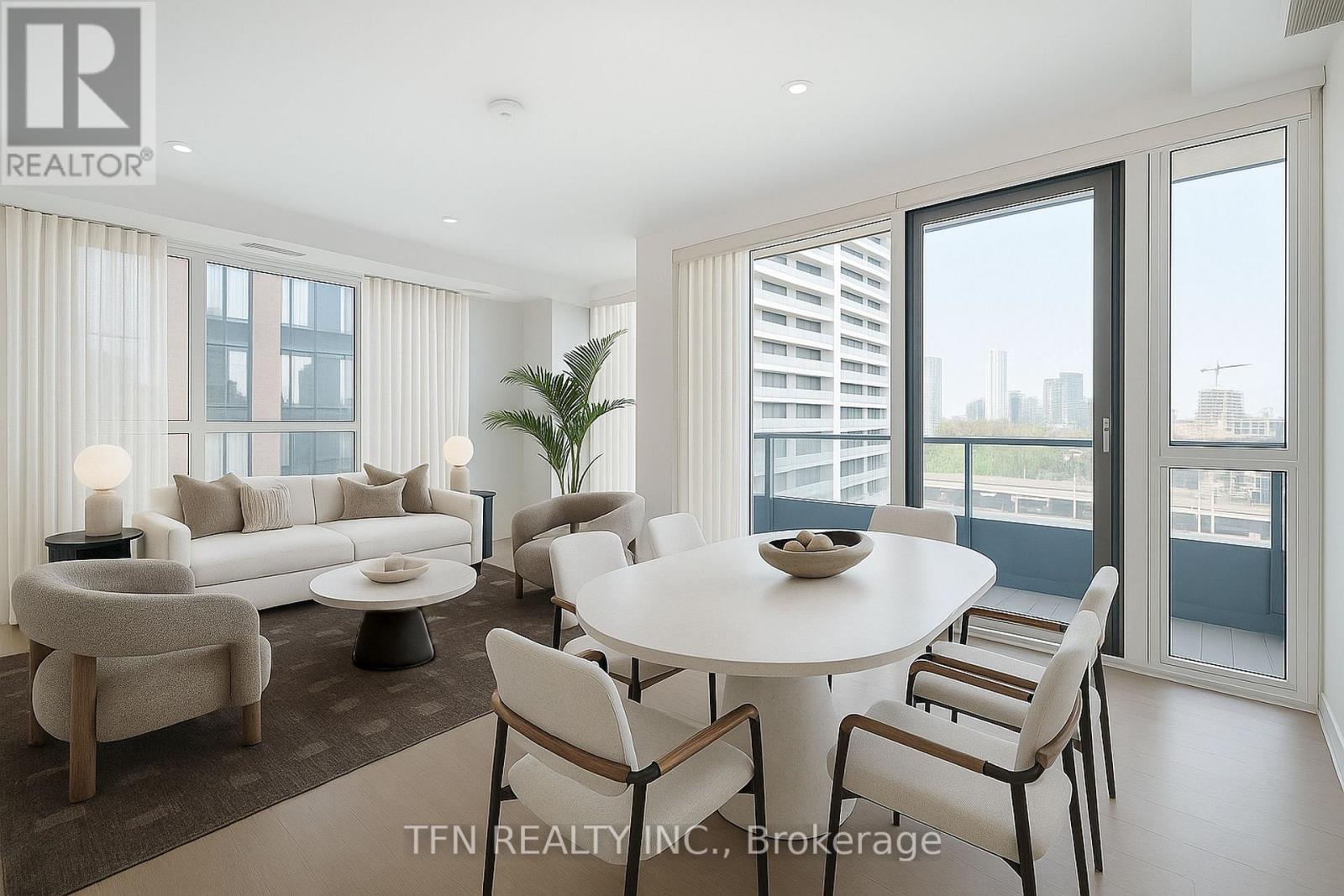 A modern dining room with a white table and chairs.